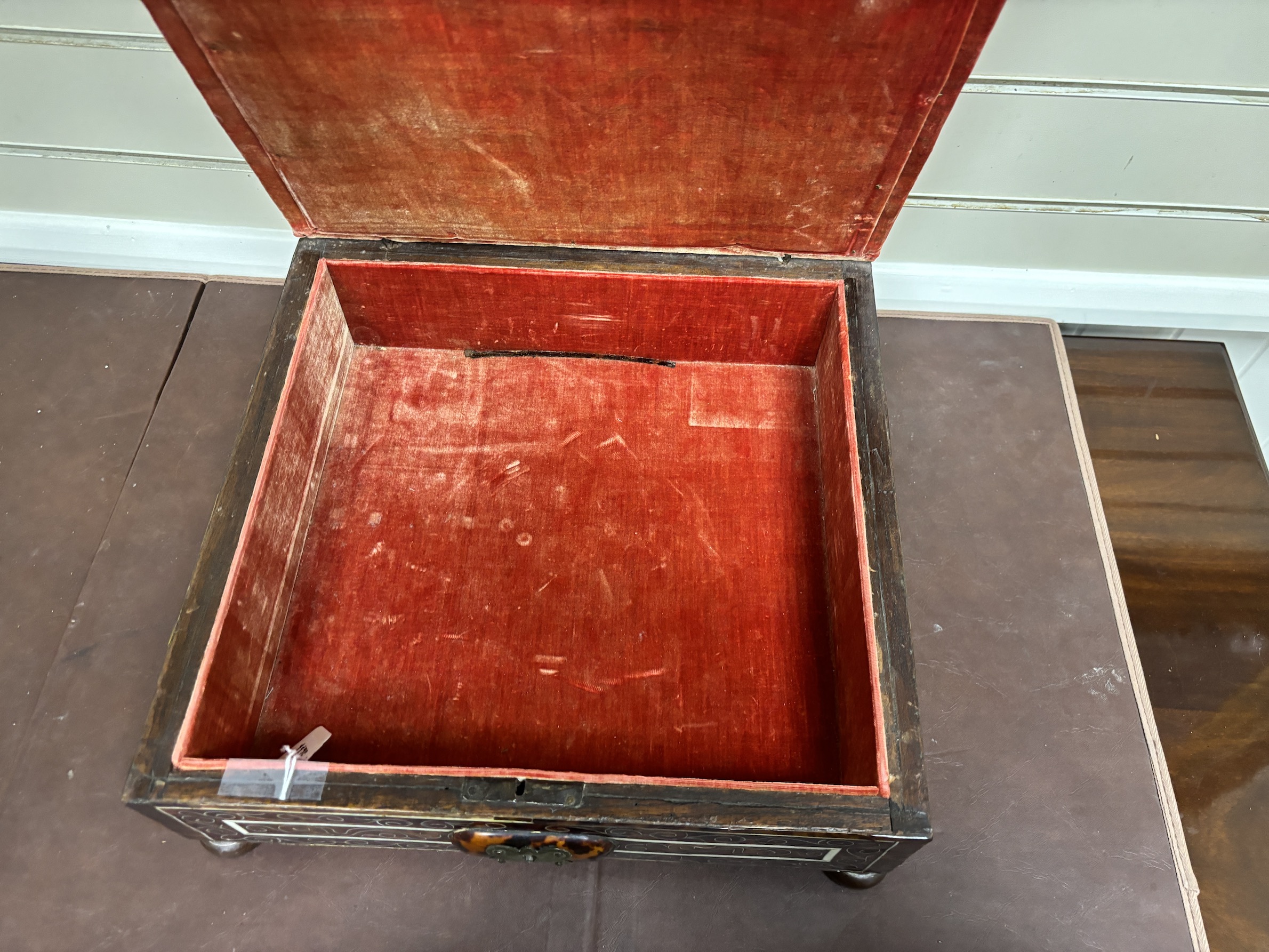 An 18th / early 19th century Portuguese tortoiseshell box with bone inlay and silk velvet lining with matching padded top, on bun feet, width 39cm, depth 38cm, height 16cm